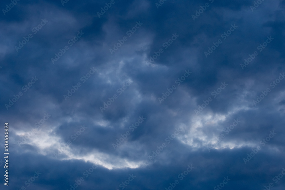 Light spot through dark rain clouds storm beam light sky weather background