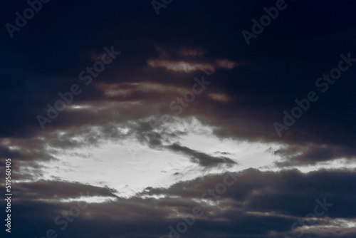 Light spot through dark rain clouds storm beam light sky weather background