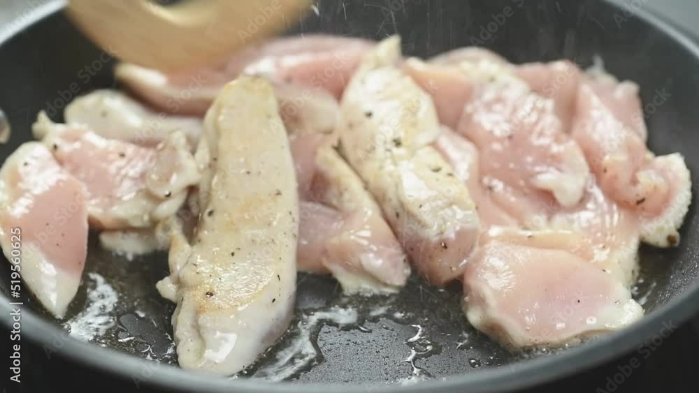 Cooking sliced chicken breast in a frying pan.
Cooking sliced chicken breast in a frying pan.