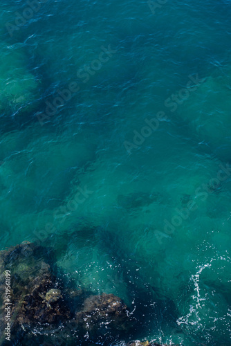 Top view of blue frothy sea surface. Shot in the open sea from above.