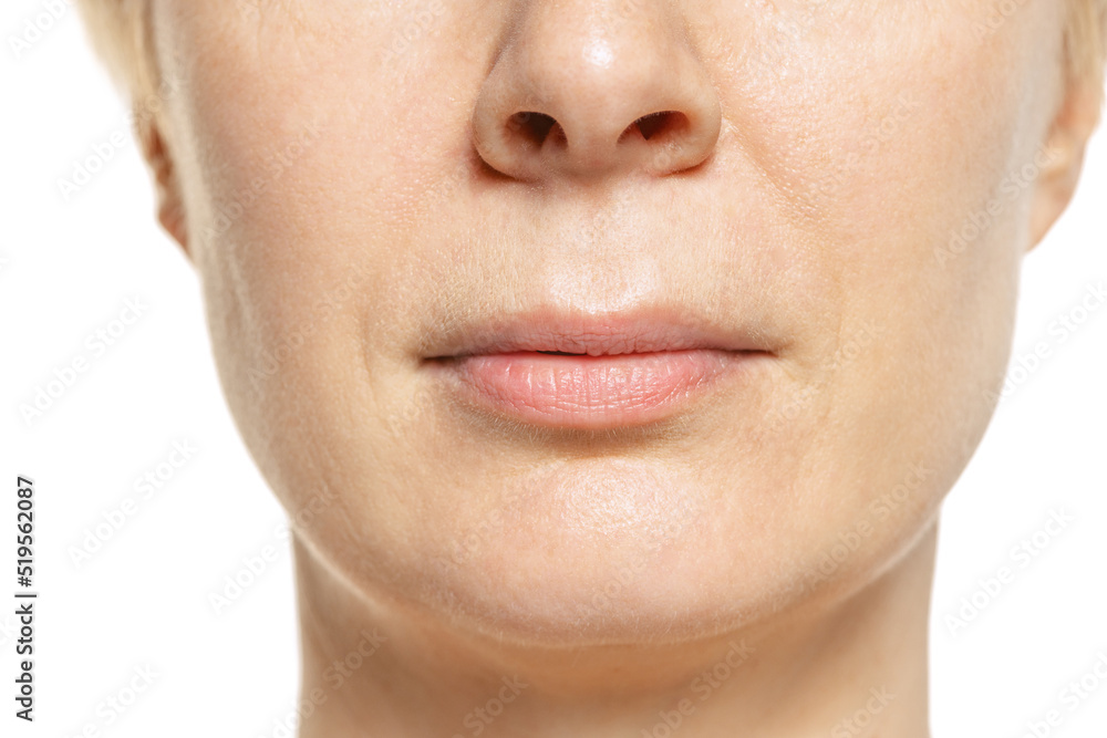 Obraz premium Close-up portrait of middle-aged woman's lips. Model isolated on white. Mimic wrinkles.