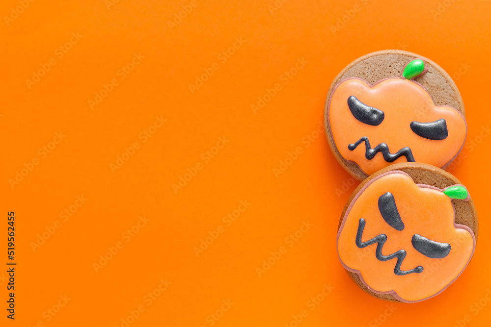 Bright gingerbread cookies for Halloween party on an orange backgound. Orange pumpkin cookies. Copy space. Top view. Bright gingerbread cookies for Halloween party on an orange backgound. Orange pumpkin cookies. Copy space. Top view.