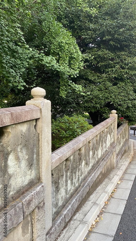 Fototapeta premium The exterior stone walls of the ancient Japanese shrine “Nezu Jinjya” in Tokyo Japan, year 2022 July 28th