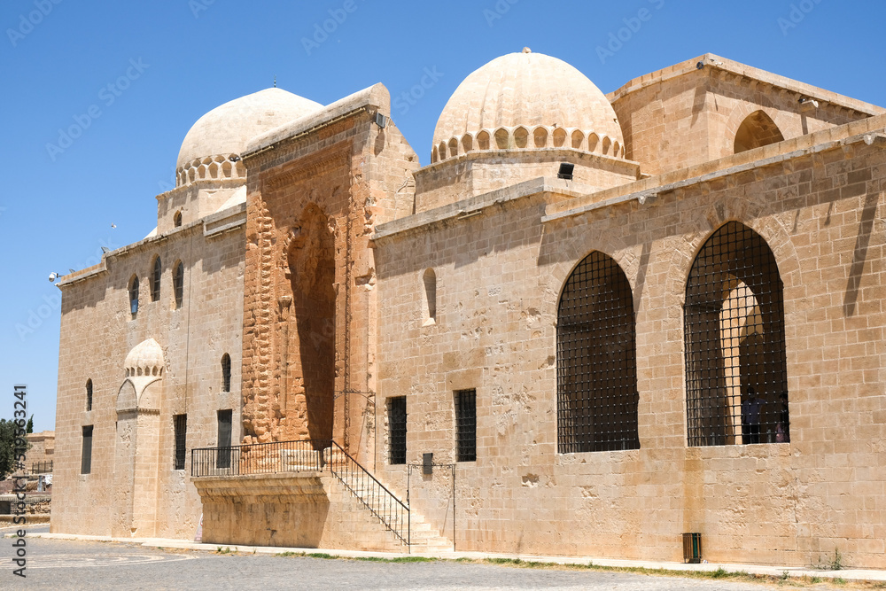 Kasımiye Madrasa exterior panoramic view from outside with blue sky in Mardin, Turkey.