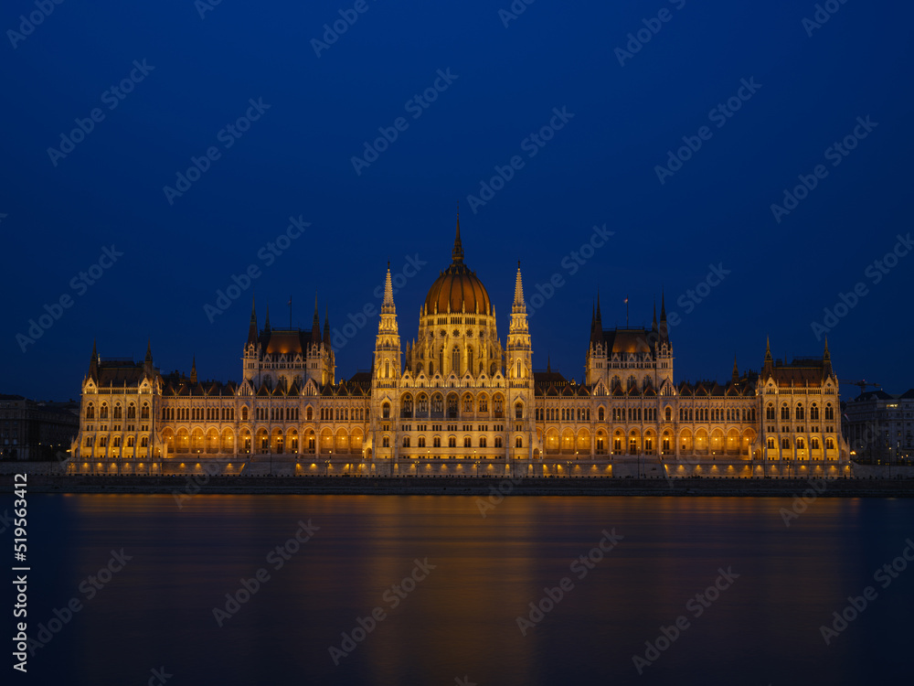 Parliament building in Budapest, Hungary. Parliament and reflections in the Danube River. Evening illumination of the building.