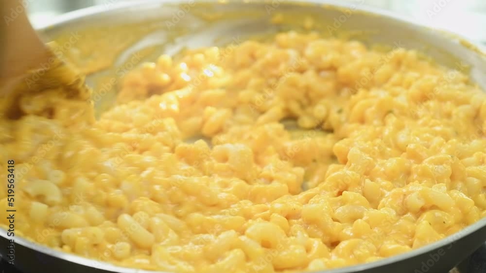 The cook prepares pumpkin mac and cheese in a frying pan.
The cook prepares pumpkin mac and cheese in a frying pan.