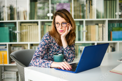 Businesswoman working on laptop in the library 