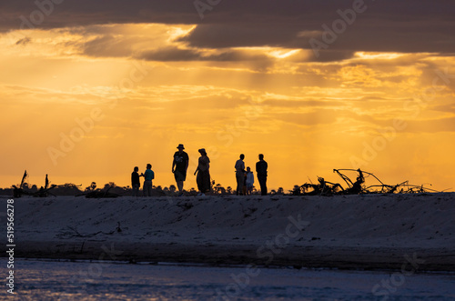 Tourists walk along a sandbank along the Rufiji River in southern Tanzania, East Africa