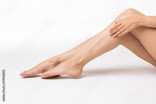 Close up female legs isolated on white background