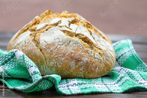 A loaf of wheat bread on a tea towel photo