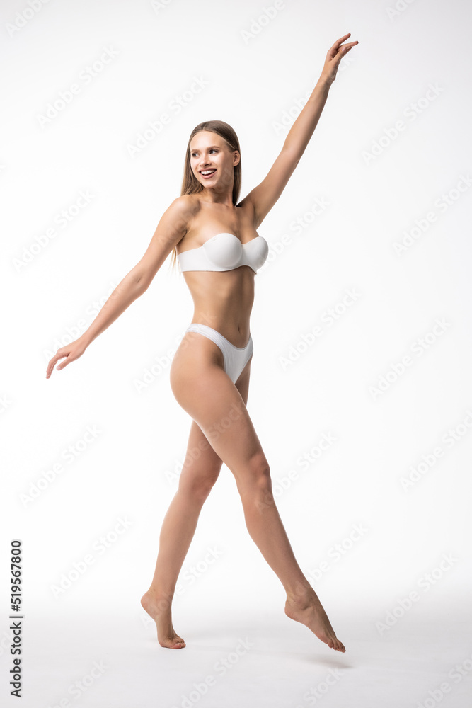 Full height of young woman with perfect body standing isolated on white background