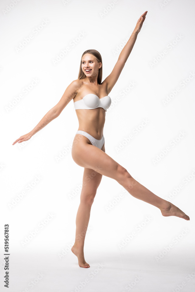 Full length portrait of smiling young woman in lingerie on white background Full length portrait of smiling young woman in lingerie on white background