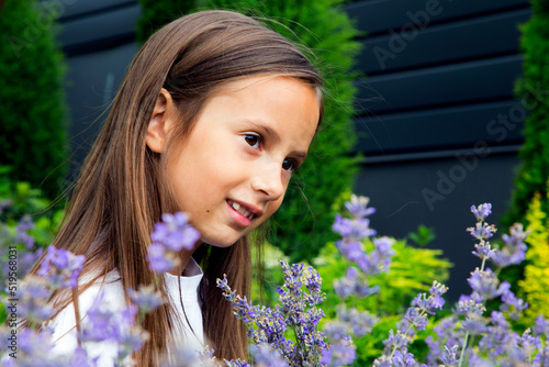 Portrait of a girl with a bouquet of lavender flowers. Happy little girl s in the park with a bouquet of lavender. The concept of childhood, happiness, beauty and nature.