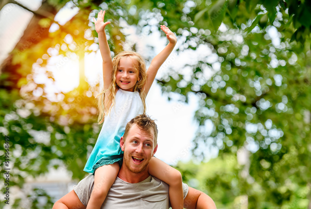 Fototapeta premium Happy Father and little daughter on shoulder outside on back street