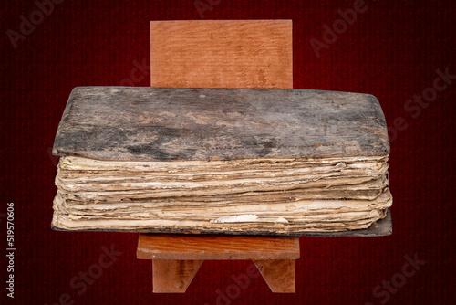 A picture of a century-old handwritten codex with a wooden cover photo