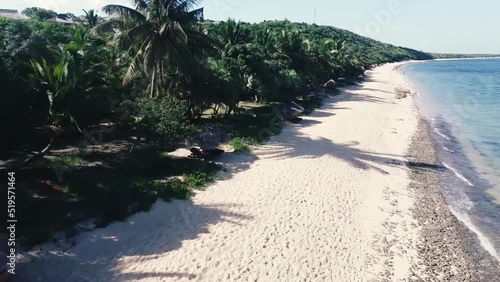 Video of a woman walking on a beach photo