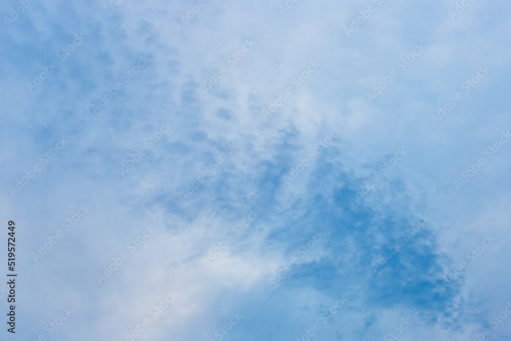 A drawn blue sky with fluffy soft white clouds of natural weather wind background