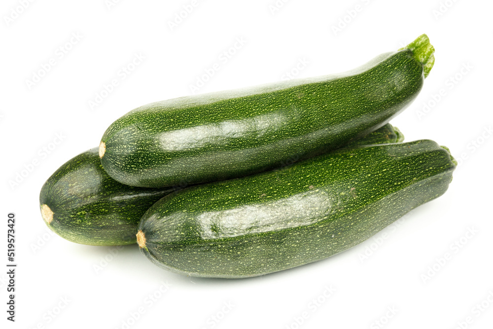 Three large zucchini on a white background, green vegetables.