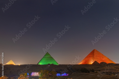 The pyramids floodlit at night, Giza, Egypt