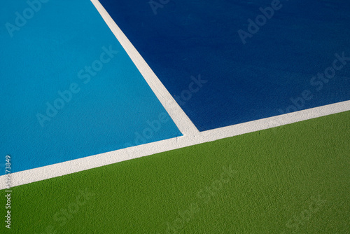 Wallpaper Mural Example image of a newly surfaced, empty pickleball court with multi-color surface and white lines