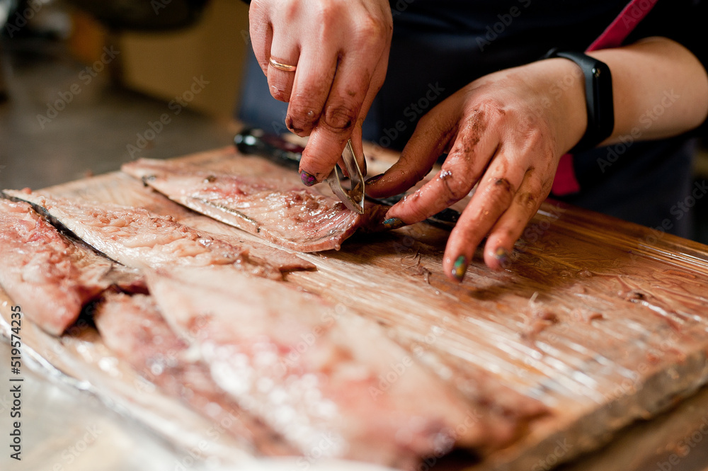 The cook separates the fillet from the fish and clears it from the bones. Mackerel fillets.