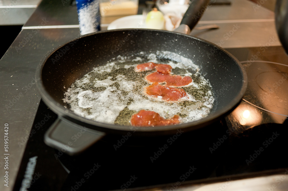 Cook fries meat in a pan with vegetables. Cook fries meat in a pan with vegetables.
