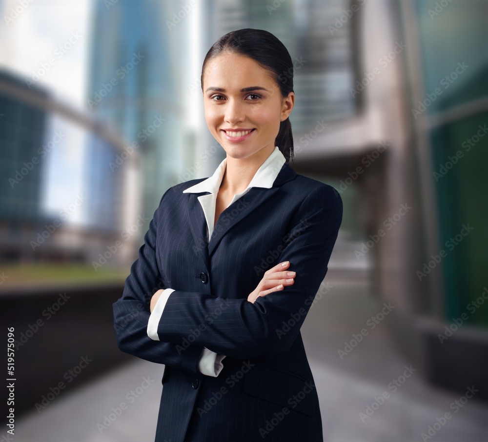 Happy attractive young businesswoman standing alone Happy attractive young businesswoman standing alone