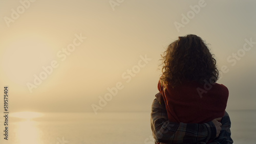 Woman and man dancing on beach at sunrise. Romantic couple hugging at sea shore © stockbusters