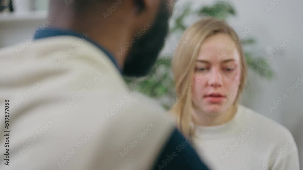 Depressed young female patient talking to psychologist at therapy session Depressed young female patient talking to psychologist at therapy session