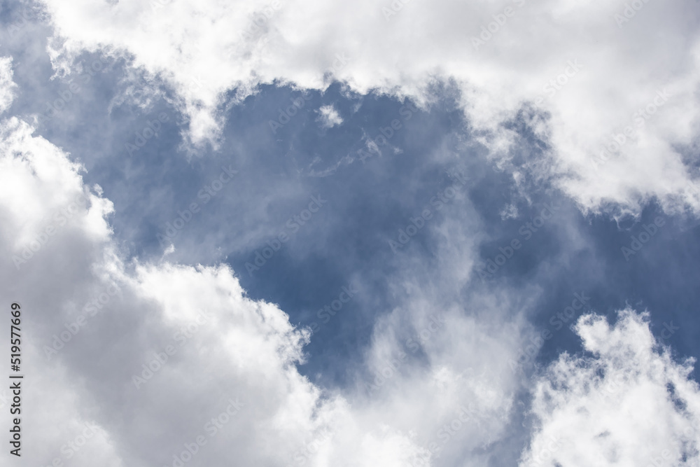 Obraz premium White cumulus clouds against a dark blue sky natural background weather change wind