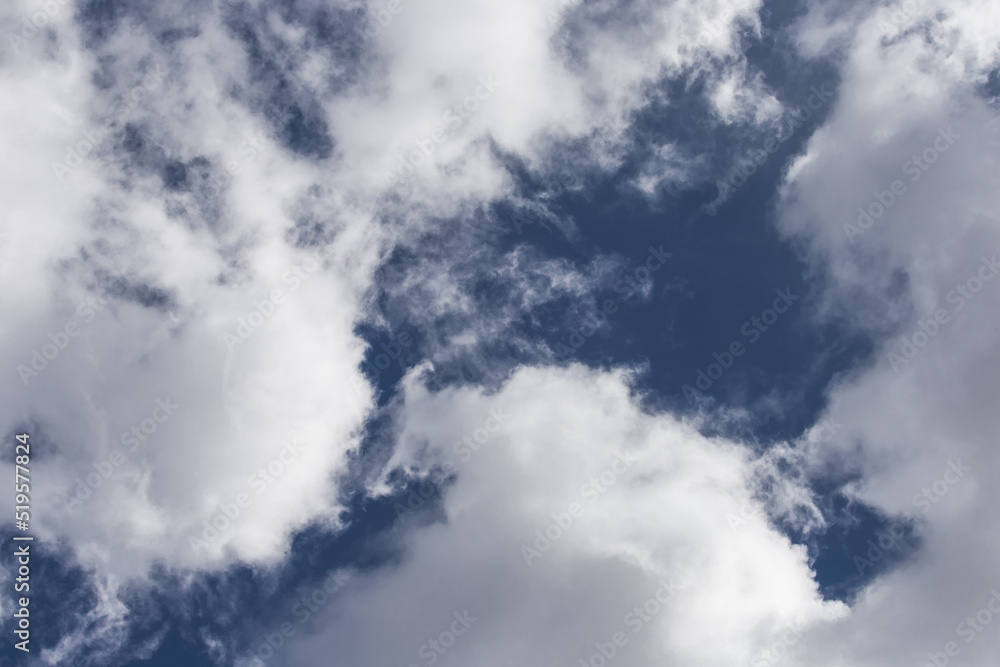 White cumulus clouds against a dark blue sky natural background weather change wind White cumulus clouds against a dark blue sky natural background weather change wind