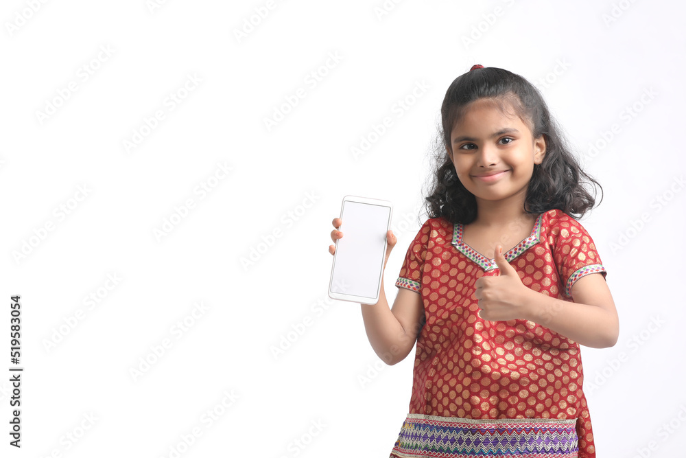 Cute indian little girl showing smartphone on white background