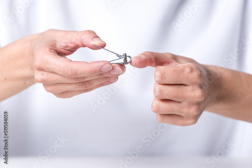  adult woman s hands cutting her nails  nail clippers  manicure at home  health and beauty  body health and beauty.