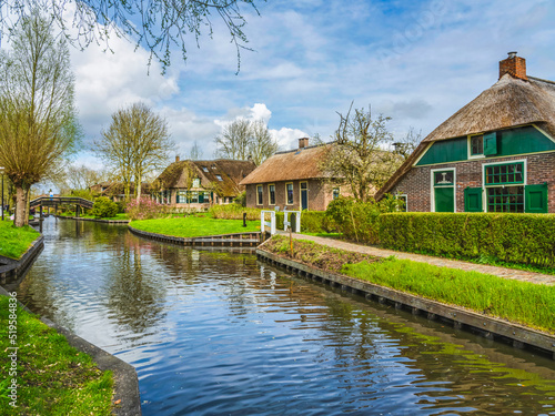 Thatched roof houses on island in Giethoorn village, Netherlands
