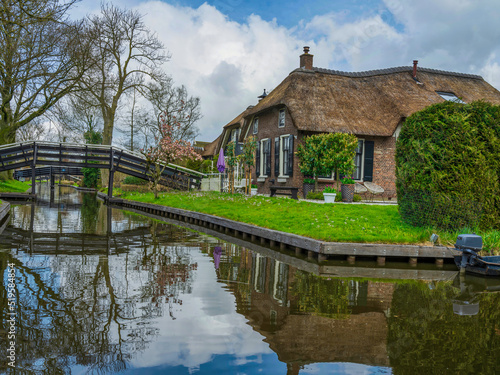 Traditional Giethoorn houses on the canal with wooden bridges, Netherlands