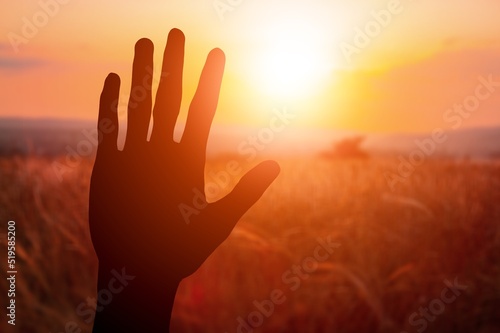 A hand silhouette sunlight. christian business love religion concept. christianity and religion belief in god.