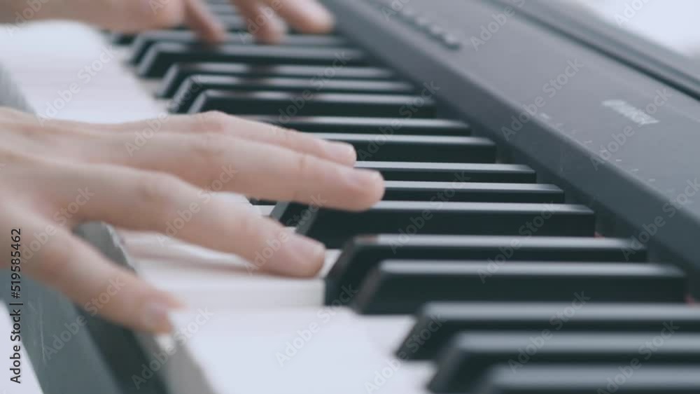 Detail of keys of an electric piano played by two hands Detail of keys of an electric piano played by two hands
