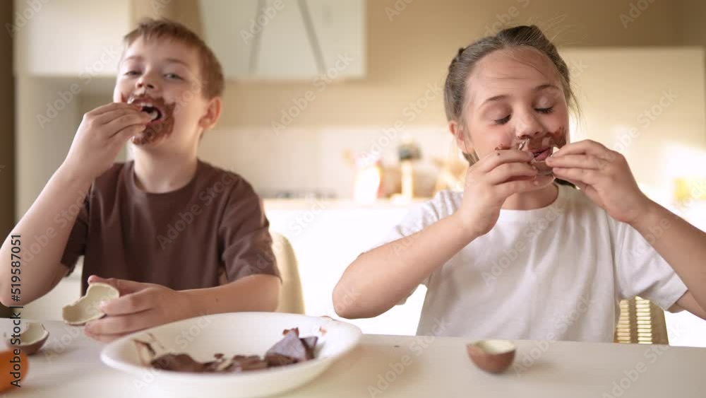 baby boy and girl eat chocolate. dirty little baby kids in the kitchen eating chocolate in the morning. happy family eating sweets kid dream concept. baby dirty face eating lifestyle chocolate cocoa baby boy and girl eat chocolate. dirty little baby kids in the kitchen eating chocolate in the morning. happy family eating sweets kid dream concept. baby dirty face eating lifestyle chocolate cocoa