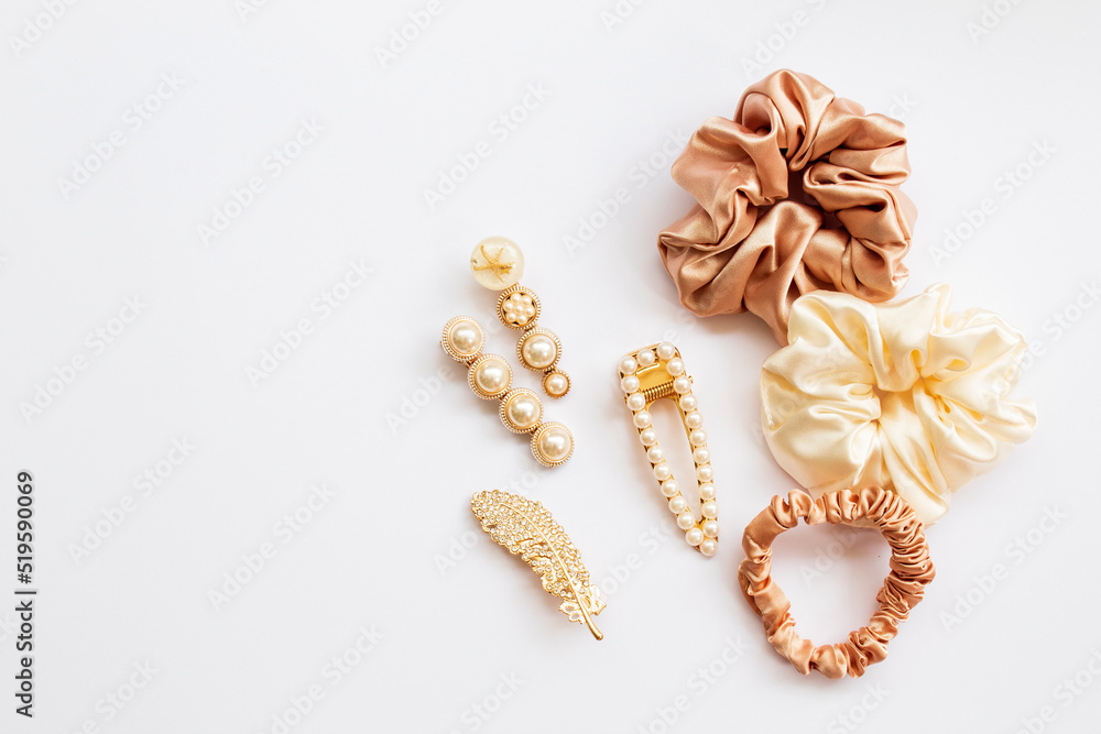 Collection of trendy silk elastic band scrunchies and pearl hair clips on white background. Diy accessories and hairstyles concept, luxury color Collection of trendy silk elastic band scrunchies and pearl hair clips on white background. Diy accessories and hairstyles concept, luxury color