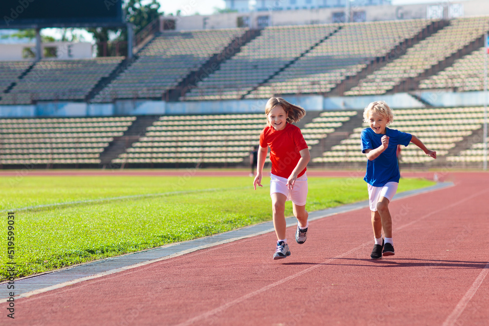 Obraz premium Child running in stadium. Kids run. Healthy sport.