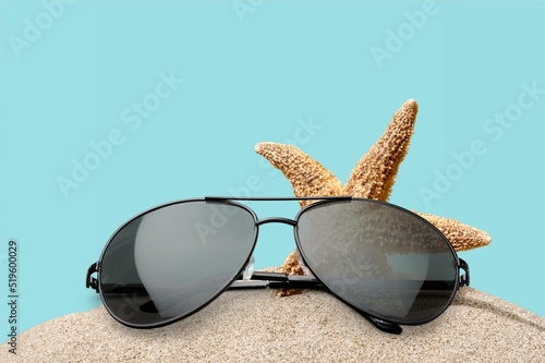Womens frame sunglasses on beach. Trendy sunglasses. Summer fashionable accessories. Optic store discount, sale.