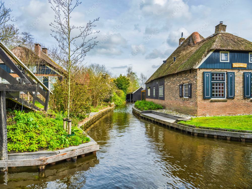 Canal side thatched roof houses in the fairy tale village of Giethoorn, Netherlands Canal side thatched roof houses in the fairy tale village of Giethoorn, Netherlands