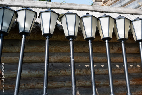 Street lights unconnected near a wooden house photo