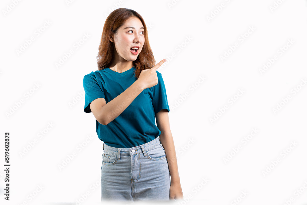 A graceful Asian woman smiles happily and points to a separate empty space on a white background. A graceful Asian woman smiles happily and points to a separate empty space on a white background.