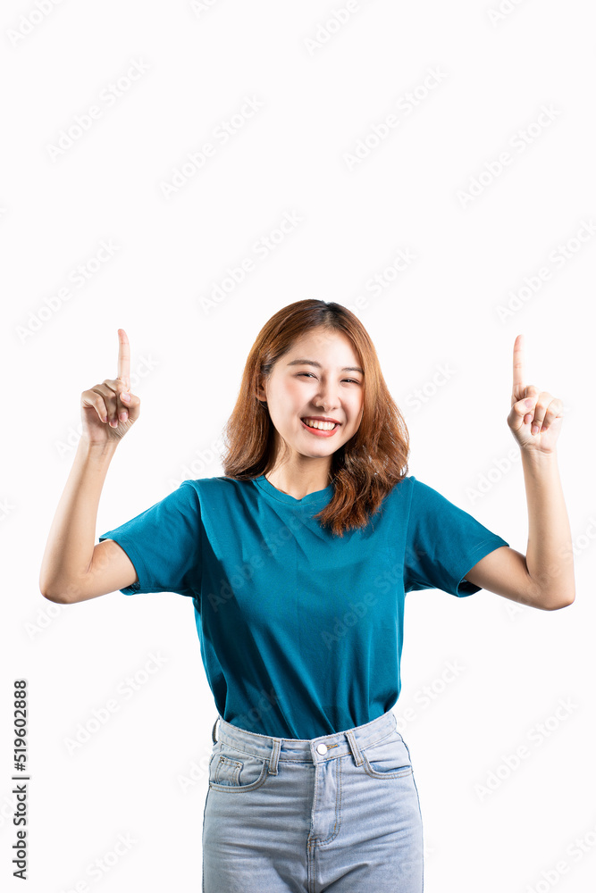 A graceful Asian woman smiles happily and points to a separate empty space on a white background. A graceful Asian woman smiles happily and points to a separate empty space on a white background.
