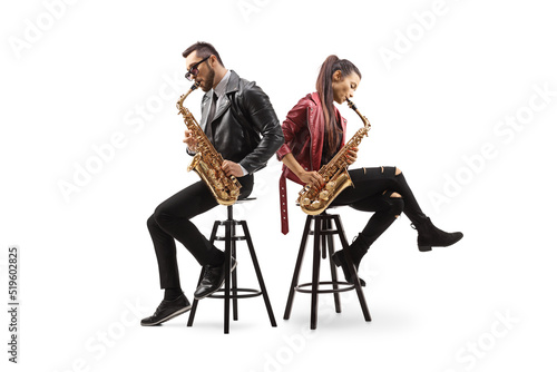 Canvastavla Modern young male and female musicians sitting back to back and playing sax