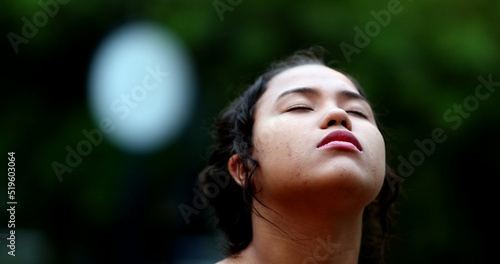 Contemplative young woman closing eyes in meditation. Close-up girl face eye closed