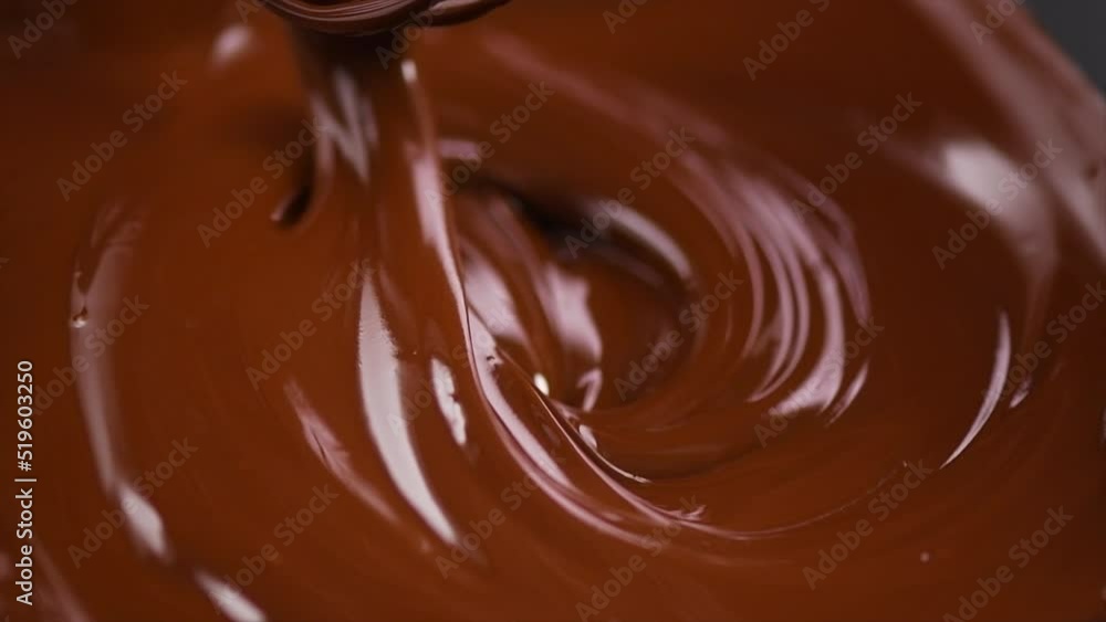 Chocolate. Mixing melted liquid premium dark chocolate with a whisk. Close up of liquid hot chocolate swirl. Confectionery. Confectioner prepares dessert, sauce. 4K UHD video, slow motion Chocolate. Mixing melted liquid premium dark chocolate with a whisk. Close up of liquid hot chocolate swirl. Confectionery. Confectioner prepares dessert, sauce. 4K UHD video, slow motion