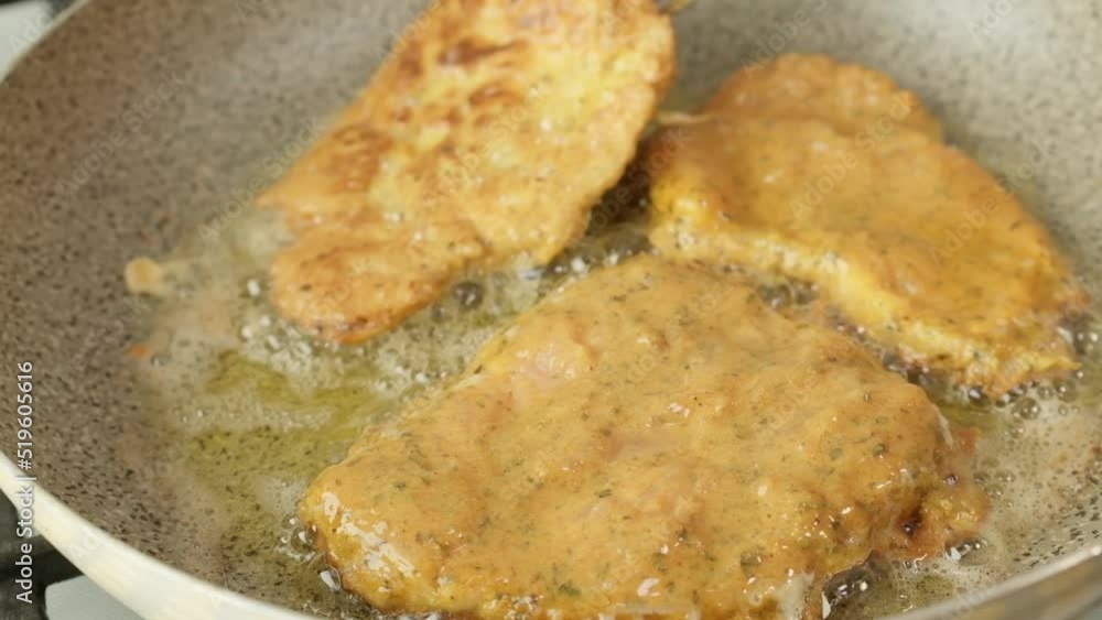 A close-up view baking a burger on a pan in the kitchen hamburgers being flipped A close-up view baking a burger on a pan in the kitchen hamburgers being flipped