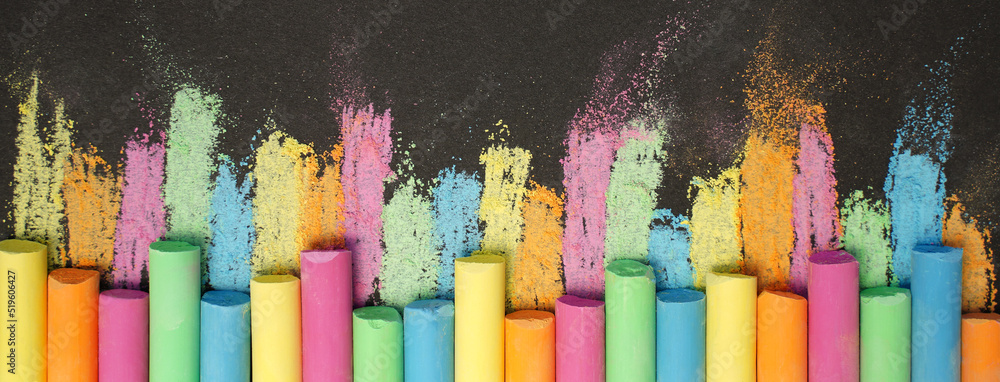 Multicolored chalk on black board. Back to school. Colored background. Banner - obrazy, fototapety, plakaty 